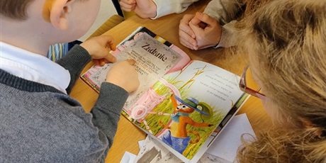Powiększ grafikę: uczniowie czytają książkę